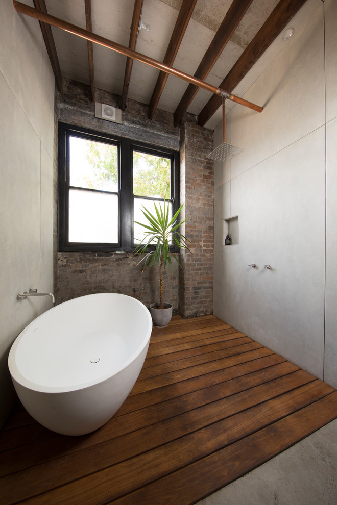 Design ideas for an industrial bathroom in Sydney with a freestanding tub and an open shower.