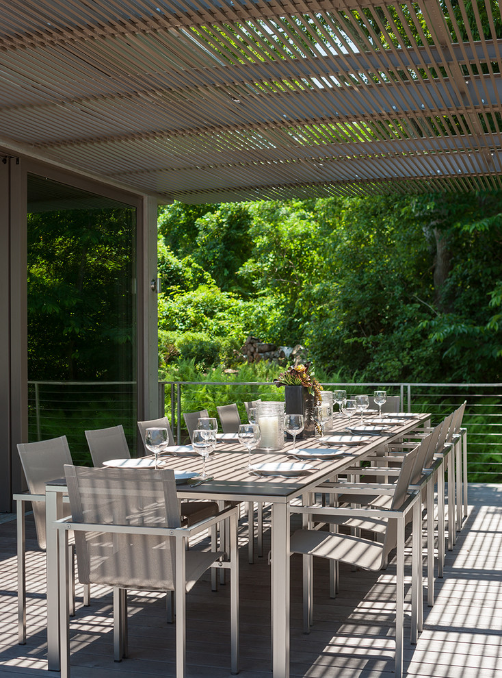 Inspiration for a large contemporary backyard deck in Boston with an outdoor kitchen and a pergola.