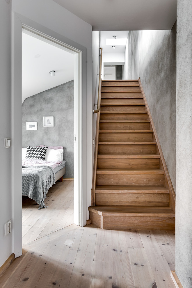 Photo of a scandinavian wood straight staircase in Stockholm with wood risers.