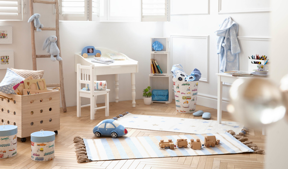 This is an example of a mid-sized scandinavian gender-neutral kids' room in Other with white walls and medium hardwood floors.