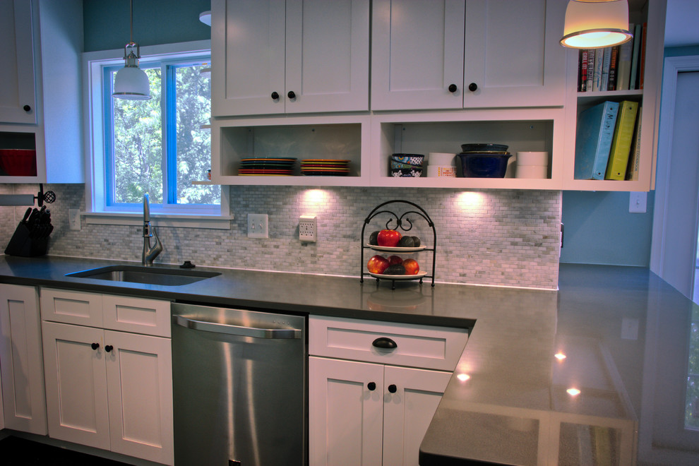 Mid-sized transitional u-shaped dark wood floor and brown floor kitchen photo in DC Metro with an undermount sink, shaker cabinets, white cabinets, quartz countertops, gray backsplash, matchstick tile backsplash, stainless steel appliances and a peninsula