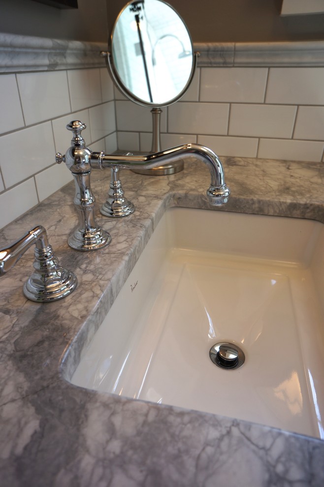 Inspiration for a mid-sized master white tile and ceramic tile porcelain tile alcove shower remodel in Minneapolis with an undermount sink, furniture-like cabinets, dark wood cabinets, marble countertops, a one-piece toilet and brown walls
