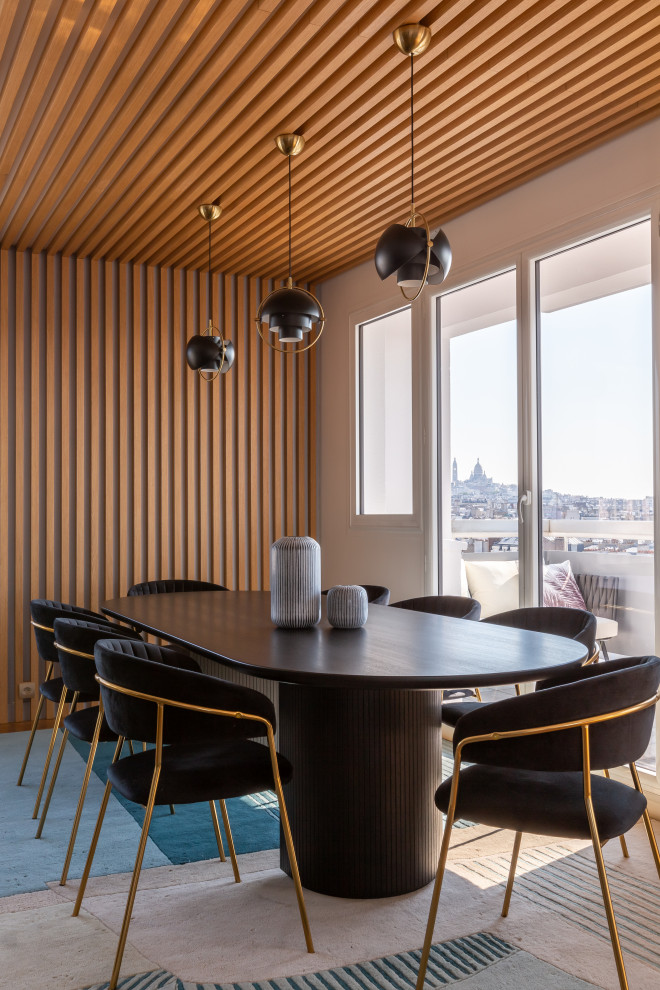 Expansive contemporary open plan dining in Paris with blue walls, light hardwood floors, no fireplace, brown floor and decorative wall panelling.