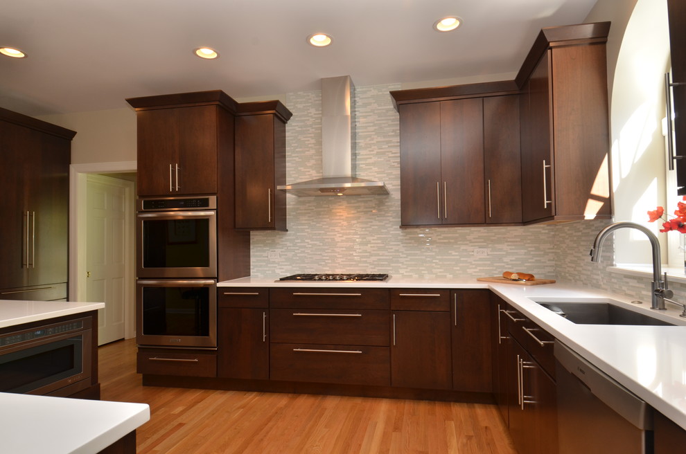 Example of a mid-sized transitional l-shaped light wood floor eat-in kitchen design in Chicago with an undermount sink, flat-panel cabinets, dark wood cabinets, quartzite countertops, multicolored backsplash, matchstick tile backsplash, stainless steel appliances and an island