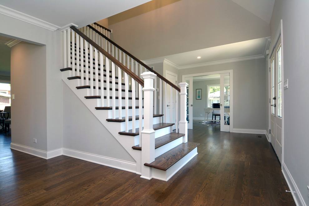 This is an example of a mid-sized traditional foyer in Chicago with grey walls, medium hardwood floors, a double front door, a white front door and brown floor.