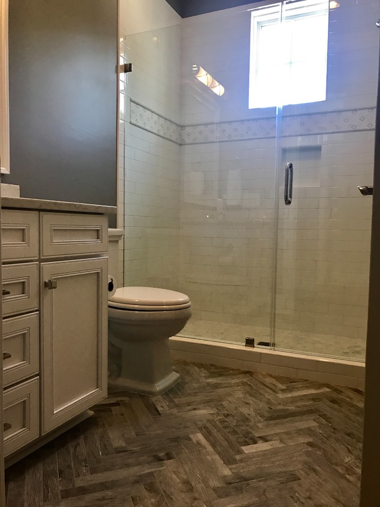 Inspiration for a transitional bathroom in Other with white cabinets, white tile, ceramic tile, grey walls, ceramic floors, granite benchtops, grey floor and a hinged shower door.