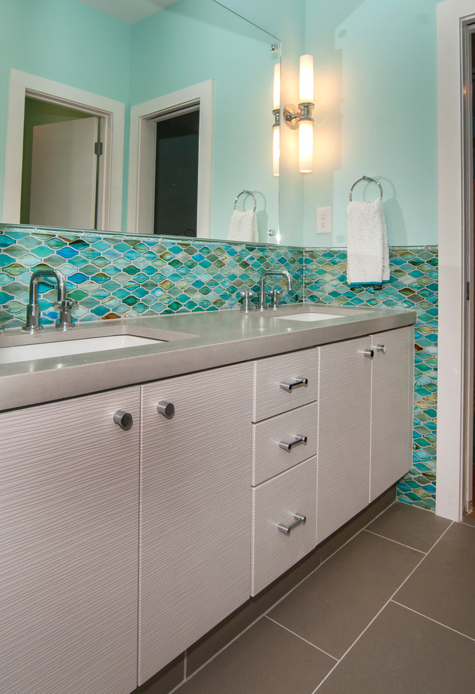 Design ideas for a small contemporary kids bathroom in Other with flat-panel cabinets, grey cabinets, green tile, glass tile, green walls, porcelain floors, a drop-in sink and concrete benchtops.