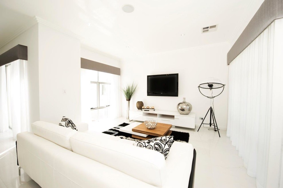 This is an example of a large modern formal open concept living room in Perth with white walls, ceramic floors, a wall-mounted tv and white floor.