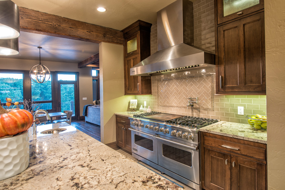 Large elegant u-shaped porcelain tile kitchen photo with a double-bowl sink, beaded inset cabinets, gray cabinets, granite countertops, beige backsplash, porcelain backsplash, stainless steel appliances and an island
