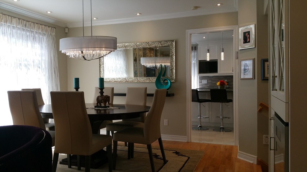 Design ideas for a mid-sized transitional open plan dining in Montreal with beige walls, medium hardwood floors and brown floor.
