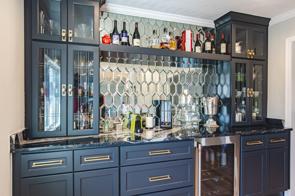 Design ideas for a mid-sized contemporary single-wall home bar in DC Metro with no sink, recessed-panel cabinets, dark wood cabinets, marble benchtops, multi-coloured splashback, glass tile splashback, medium hardwood floors, beige floor and black benchtop.