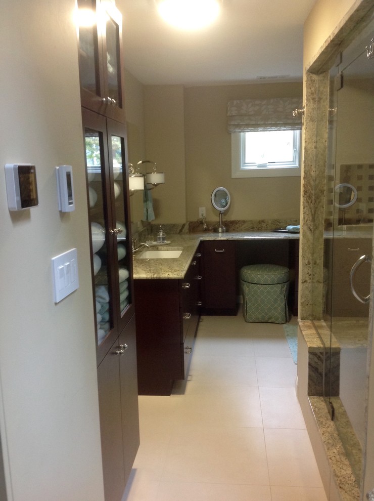Large transitional master beige tile and porcelain tile porcelain tile home design photo in Boston with an undermount sink, flat-panel cabinets, dark wood cabinets, granite countertops, a wall-mount toilet and beige walls