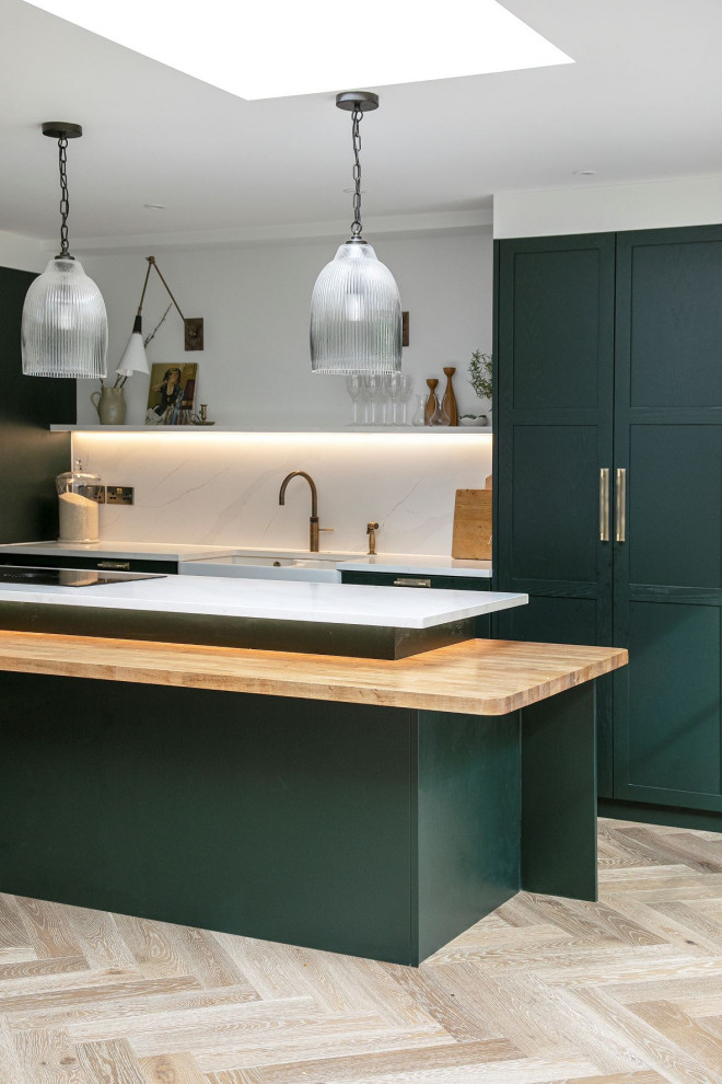 Design ideas for a contemporary l-shaped open plan kitchen in Other with shaker cabinets, green cabinets, quartz worktops, white splashback, engineered quartz splashback, integrated appliances, an island and white worktops.