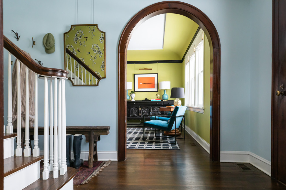Inspiration for an eclectic entrance in Chicago with blue walls, dark hardwood flooring, a double front door, a medium wood front door and brown floors.