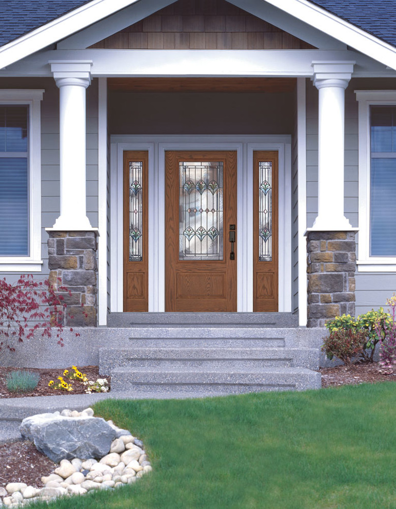 Example of a large front door design with a glass front door