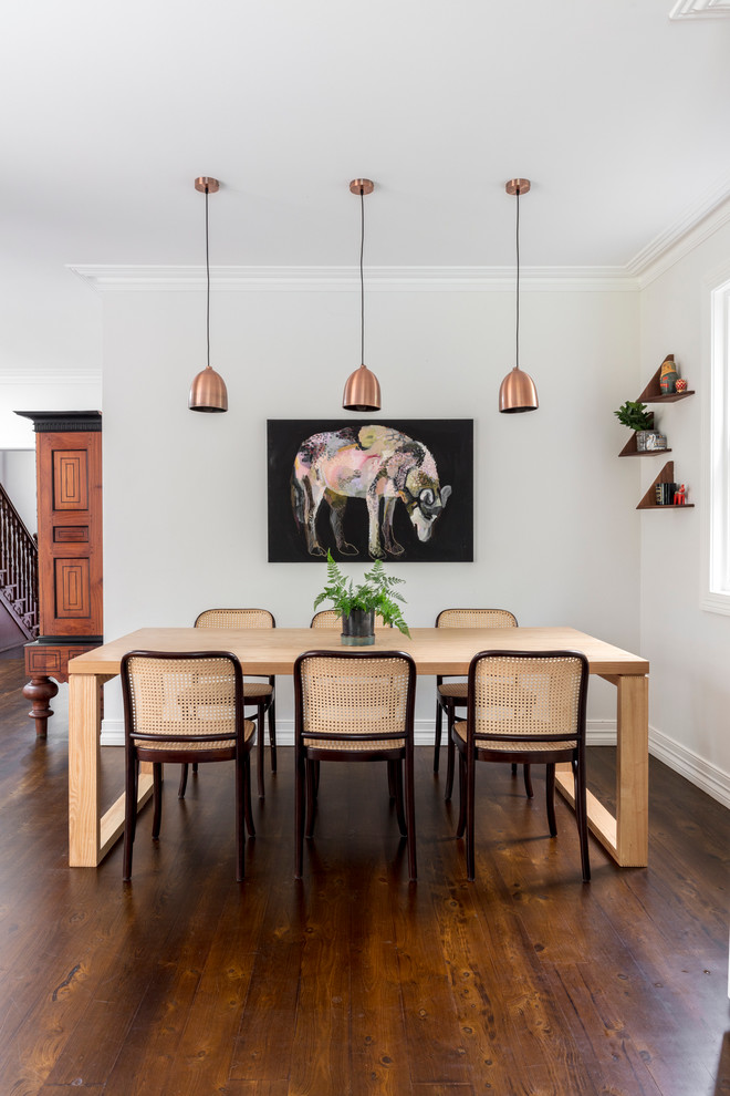 Mid-sized transitional kitchen/dining combo in Sydney with white walls and medium hardwood floors.
