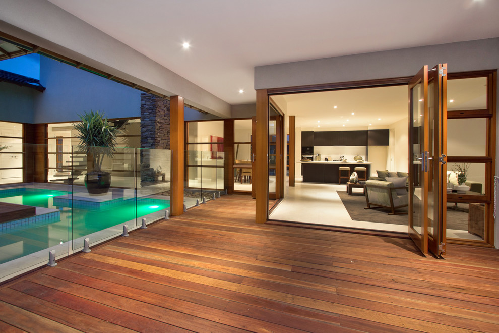 Photo of a tropical patio in Melbourne with decking and a roof extension.