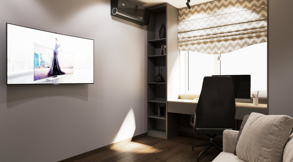 Foto på ett mellanstort funkis arbetsrum, med ett bibliotek, grå väggar, laminatgolv, ett fristående skrivbord och brunt golv