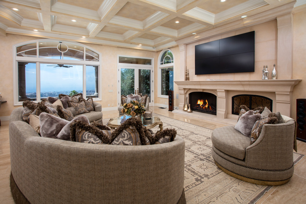 Design ideas for a large transitional open concept family room in Orange County with beige walls, travertine floors, a standard fireplace, a stone fireplace surround, a wall-mounted tv and beige floor.
