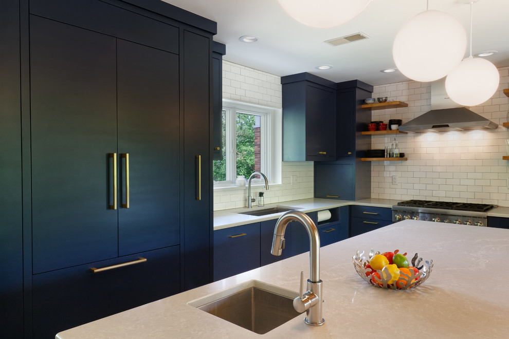 Example of a mid-century modern cork floor and gray floor kitchen design in Cincinnati with flat-panel cabinets, blue cabinets, an island, an undermount sink, quartzite countertops, white backsplash, ceramic backsplash, paneled appliances and white countertops