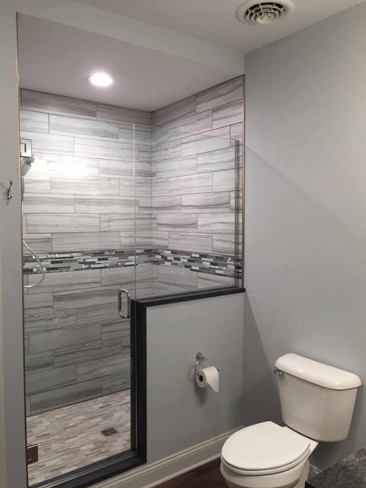Design ideas for a small transitional bathroom in Chicago with shaker cabinets, grey cabinets, an alcove shower, gray tile, porcelain tile, brown walls, dark hardwood floors, an undermount sink, recycled glass benchtops, brown floor and a hinged shower door.