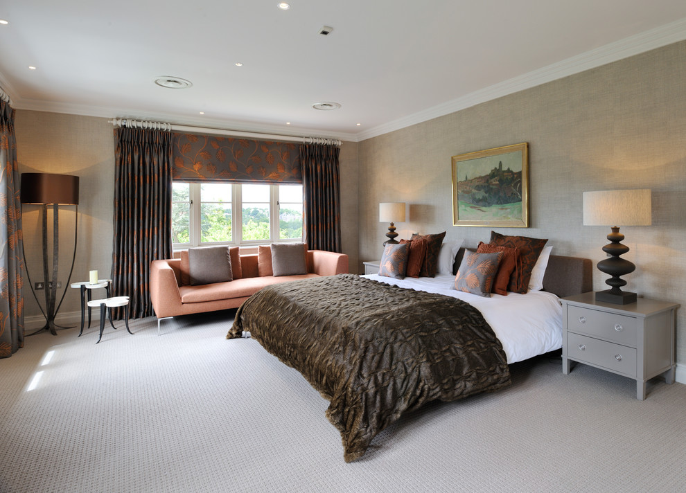 Design ideas for a transitional master bedroom in London with orange walls, carpet and beige floor.