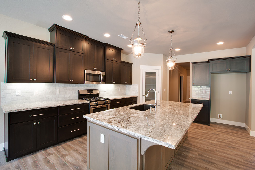 Kitchen - transitional kitchen idea in Seattle with shaker cabinets, dark wood cabinets, multicolored backsplash and subway tile backsplash