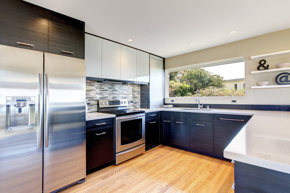 Photo of a small contemporary single-wall kitchen pantry in Sydney with an integrated sink, dark wood cabinets, quartz benchtops, multi-coloured splashback, mosaic tile splashback, stainless steel appliances, light hardwood floors, a peninsula and brown floor.