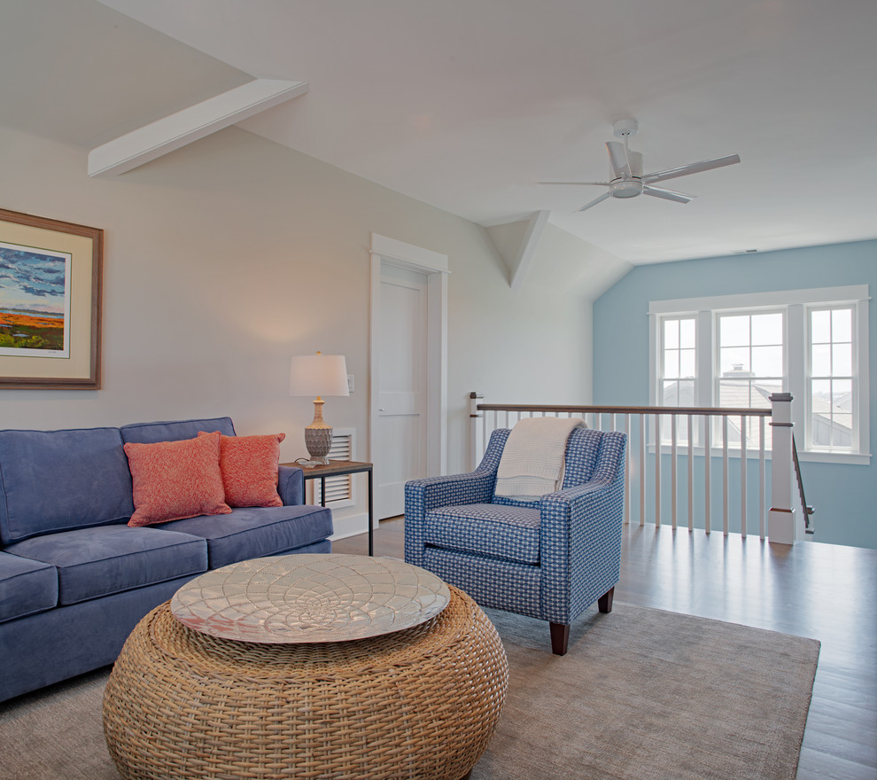 Design ideas for a mid-sized beach style formal loft-style living room in Charleston with beige walls, medium hardwood floors, no tv and brown floor.