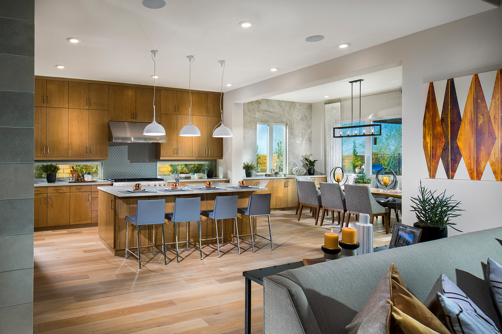 Inspiration for a mid-sized l-shaped eat-in kitchen in San Diego with flat-panel cabinets, medium wood cabinets, multi-coloured splashback, stainless steel appliances, light hardwood floors, with island and multi-coloured floor.
