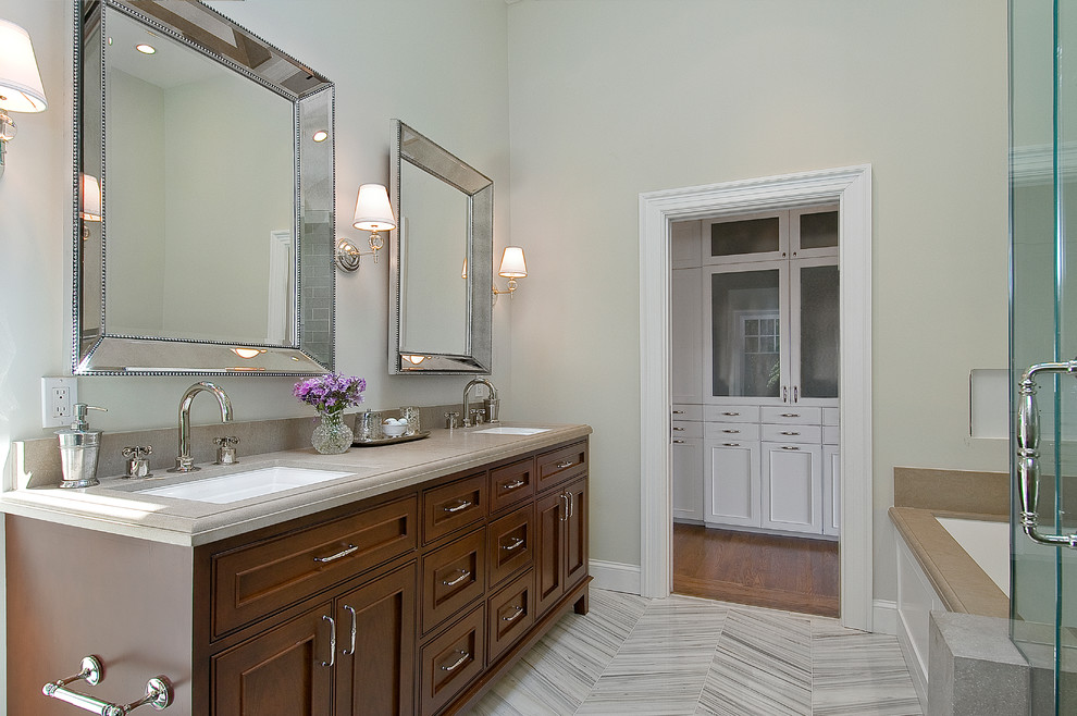 This is an example of a large traditional master bathroom in San Francisco with beaded inset cabinets, medium wood cabinets, a hinged shower door, an undermount tub, a corner shower, gray tile, ceramic tile, beige walls, vinyl floors, an undermount sink, stainless steel benchtops and grey floor.