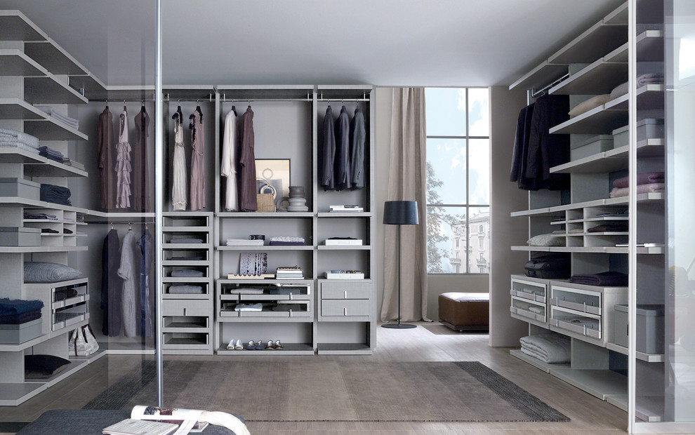 Photo of a small contemporary men's walk-in wardrobe in Dorset with glass-front cabinets and grey cabinets.