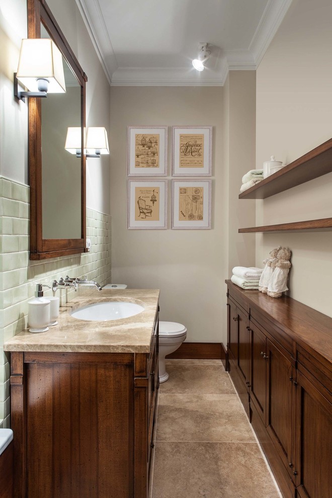 Design ideas for a country bathroom in Moscow with medium wood cabinets, a two-piece toilet, beige walls, an undermount sink, marble benchtops and brown floor.