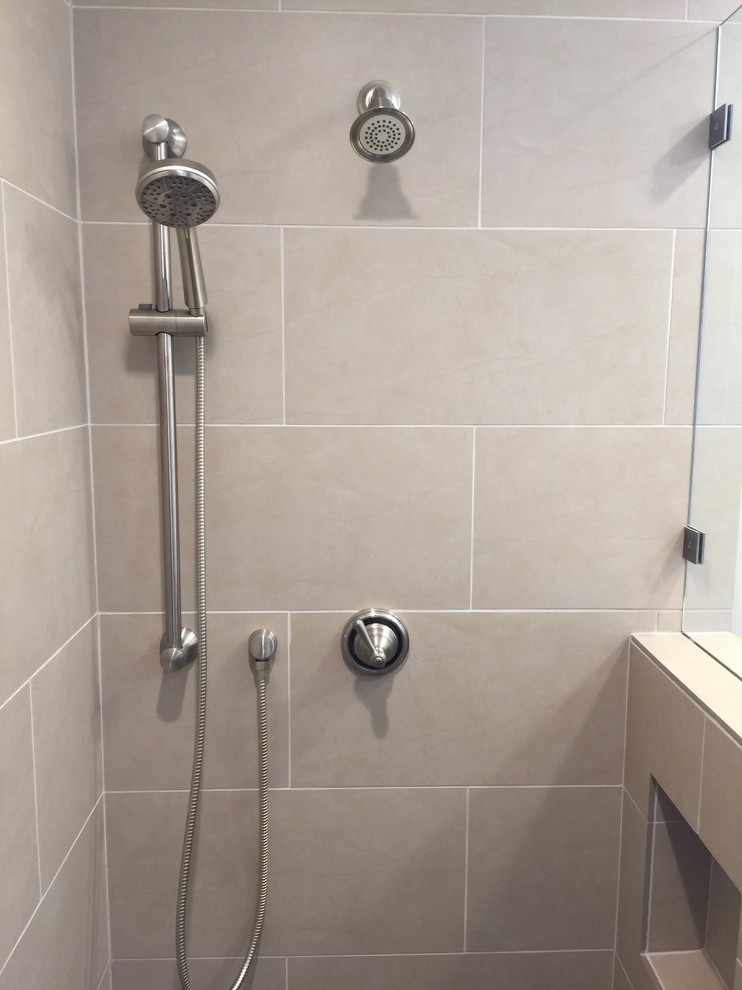 Transitional bathroom in San Luis Obispo with a corner shower, gray tile and porcelain tile.