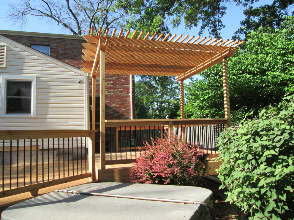Photo of a country backyard deck in St Louis with a pergola.