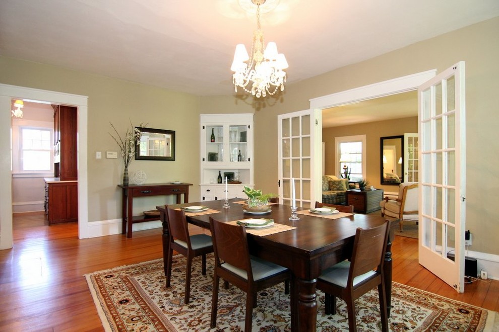 Photo of a large traditional separate dining room in Milwaukee with green walls, medium hardwood floors and no fireplace.