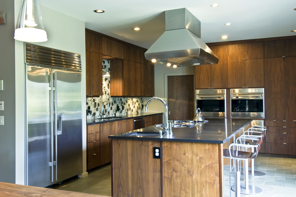 Design ideas for a large midcentury galley open plan kitchen in Other with an undermount sink, flat-panel cabinets, dark wood cabinets, granite benchtops, multi-coloured splashback, ceramic splashback, stainless steel appliances, slate floors and with island.