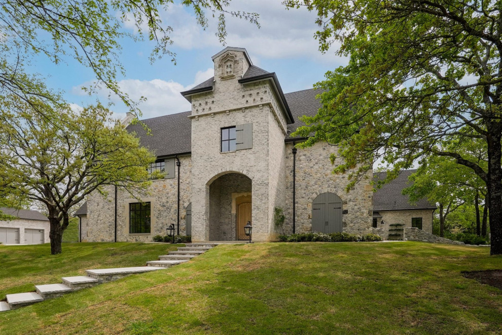 Design ideas for an expansive two floor house exterior in Dallas with stone cladding.