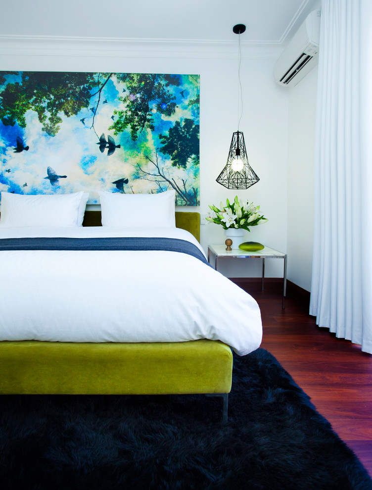 Design ideas for a mid-sized eclectic guest bedroom in Perth with white walls, dark hardwood floors and brown floor.