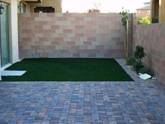 Photo of a small contemporary backyard full sun xeriscape for summer in Las Vegas with brick pavers.