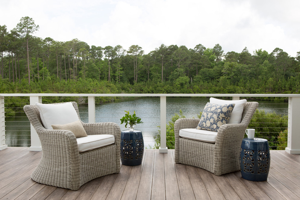 Design ideas for a mid-sized eclectic backyard deck in Charleston with with dock.