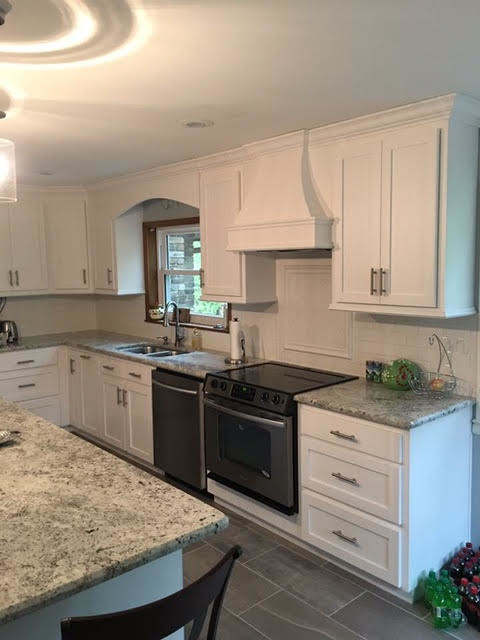 Eat-in kitchen - large transitional u-shaped gray floor eat-in kitchen idea in Birmingham with a double-bowl sink, shaker cabinets, white cabinets, white backsplash, stainless steel appliances and an island