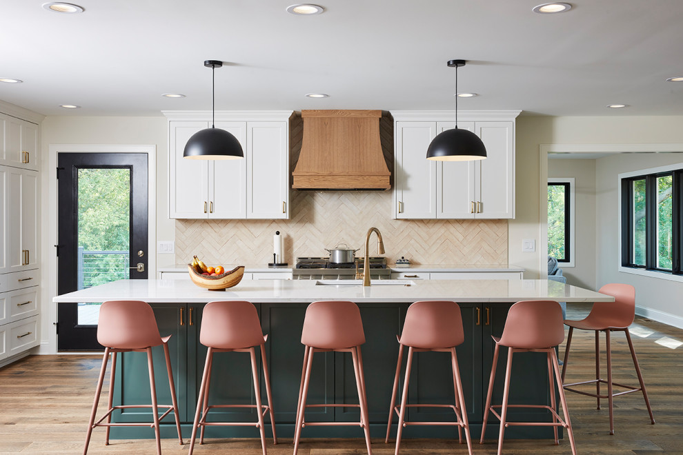 Huge trendy medium tone wood floor and brown floor kitchen photo in Minneapolis with an undermount sink, flat-panel cabinets, green cabinets, quartz countertops, beige backsplash, cement tile backsplash, stainless steel appliances, an island and white countertops