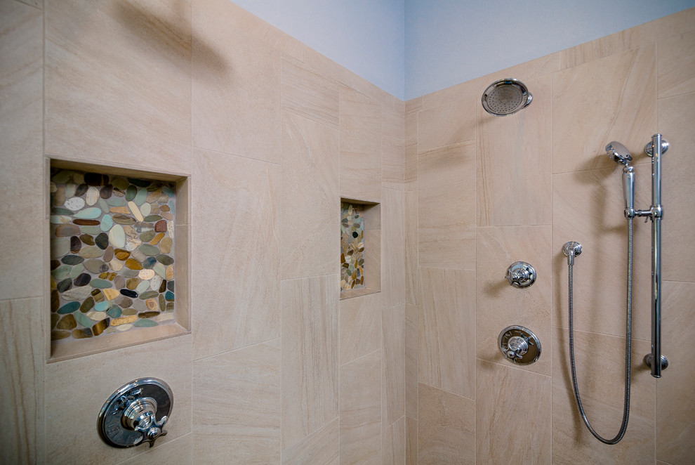 Example of a large transitional master beige tile and porcelain tile porcelain tile and brown floor drop-in bathtub design with shaker cabinets, white cabinets, a one-piece toilet, blue walls, an undermount sink, quartz countertops and a hinged shower door