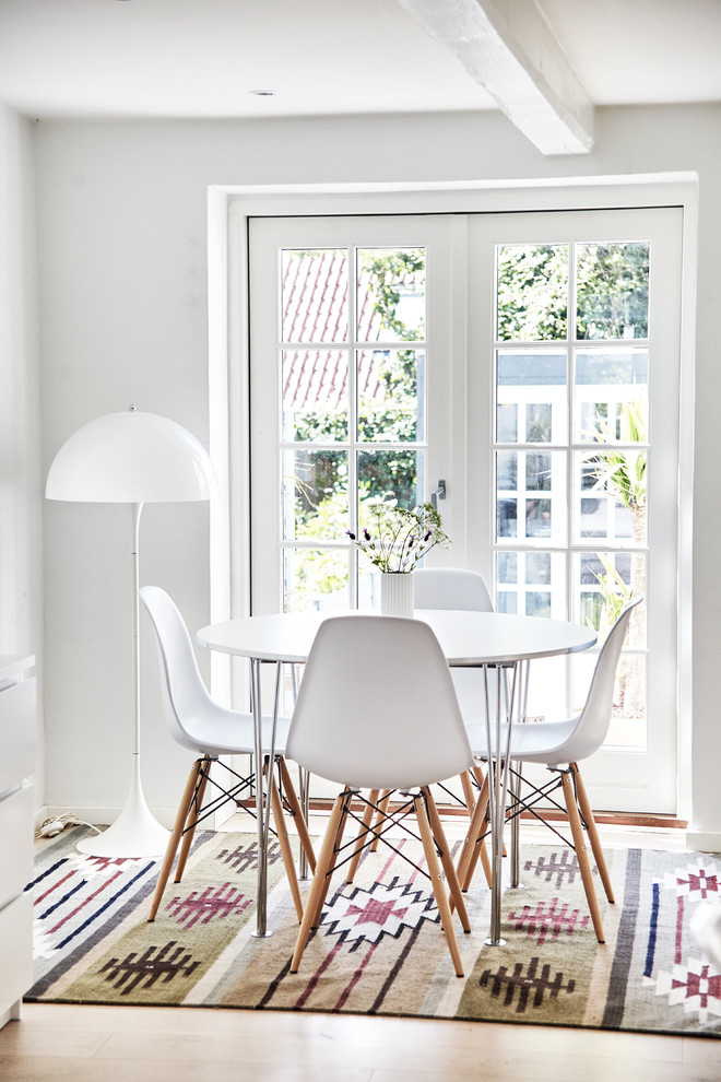 Inspiration for a mid-sized scandinavian dining room in Other with white walls, light hardwood floors and no fireplace.