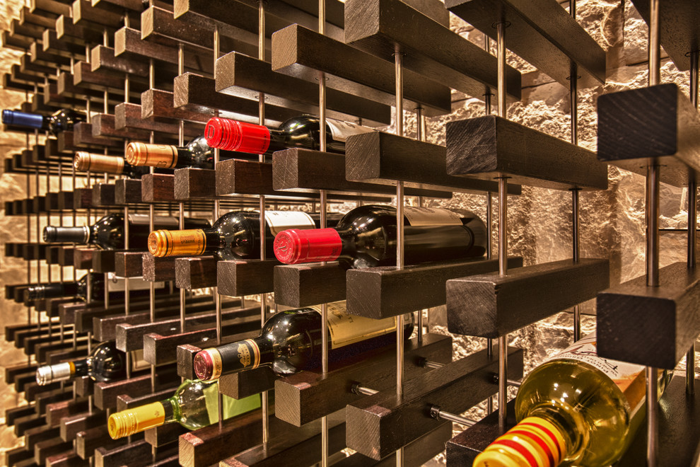 Photo of a contemporary wine cellar in Boston with travertine floors, display racks and grey floor.
