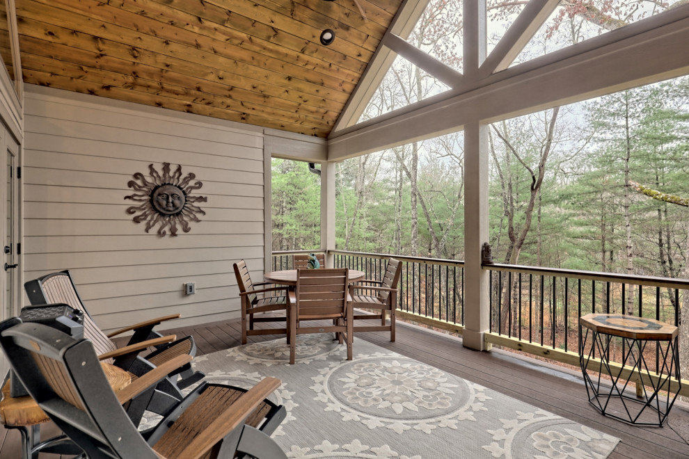 Mid-sized arts and crafts backyard and first floor deck in Atlanta with a roof extension and mixed railing.