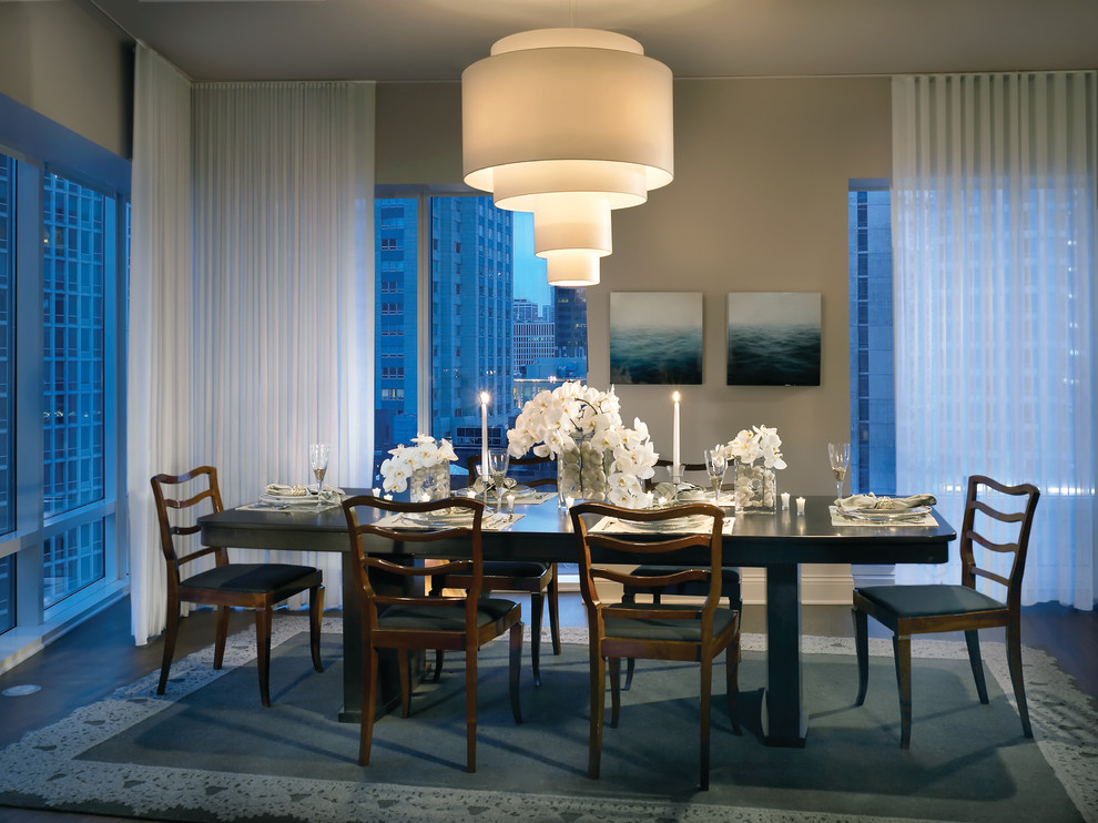 This is an example of a contemporary dining room in Chicago with beige walls and dark hardwood floors.