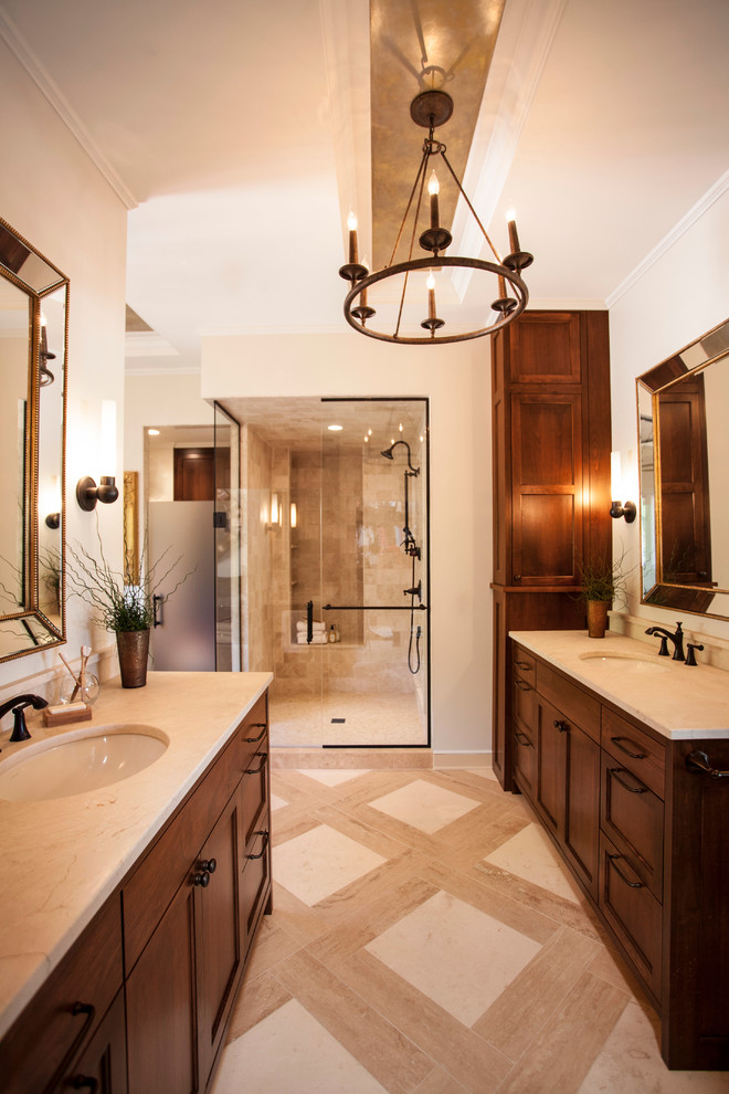 Inspiration for a large traditional master bathroom in Minneapolis with flat-panel cabinets, medium wood cabinets, a freestanding tub, an alcove shower, a one-piece toilet, beige tile, stone tile, beige walls, travertine floors, an undermount sink and marble benchtops.