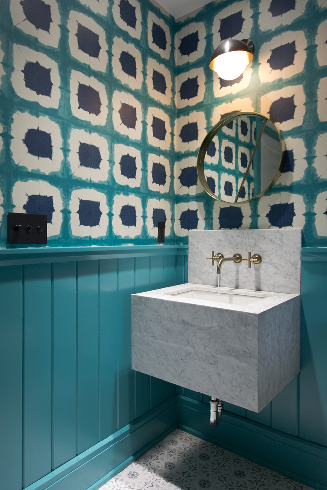This is an example of a small eclectic 3/4 bathroom in New York with blue walls and white benchtops.